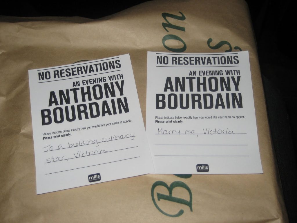 two pieces of paper that say No Reservations An Evening with Anthony Bourdain