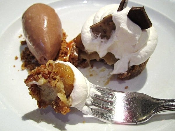 a forkful of banana pretzel cream pie with chocolate ice cream behind it