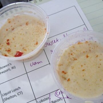 two small cups of white chowder on a notepad used as a tray