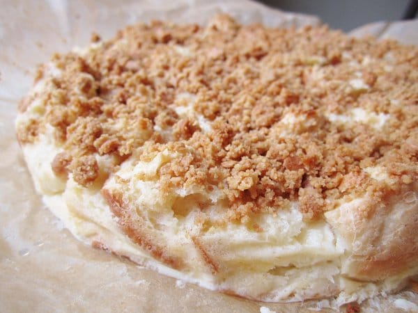 side view of a cake shaped bread pudding topped with crumbs