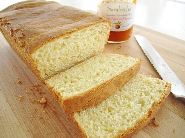 A loaf of brioche with 2 slices cut from it