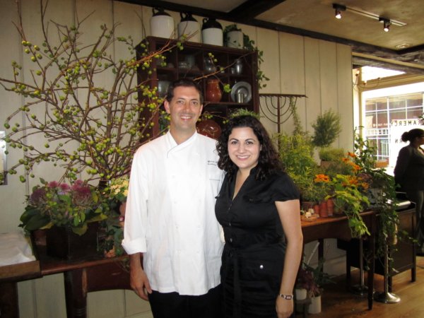 A man and a woman standing in a room and posing for the camera