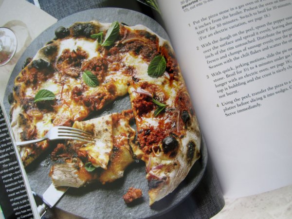 snapshot of a photo of a pizza in a cookbook
