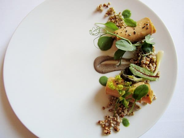 overhead view of a white plate with tan and green foods arranged on the right side
