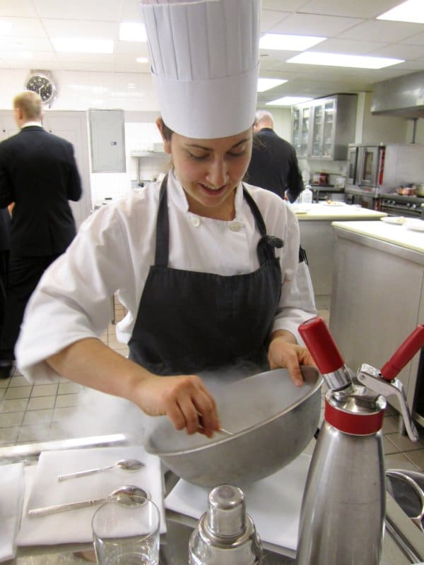 A person cooking in a professional kitchen