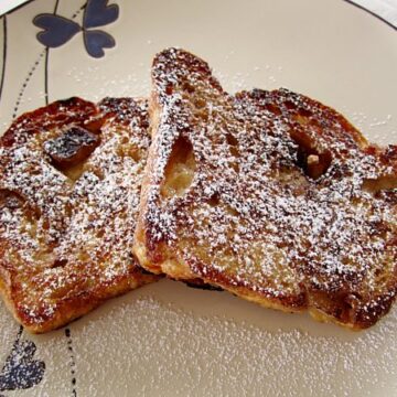 overhead view of two slices of French toast topped with powdered sugar