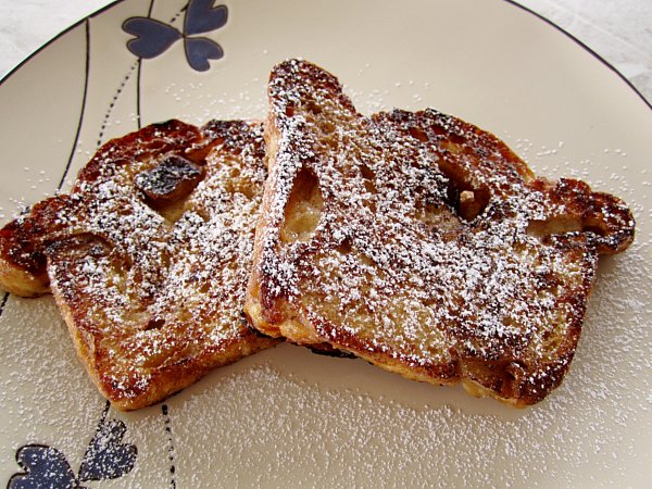 overhead view of two slices of French toast topped with powdered sugar