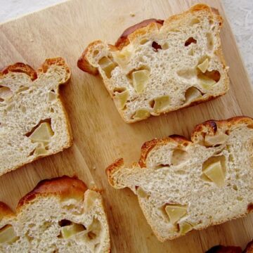 overhead view of slices of apple bread on a wooden board