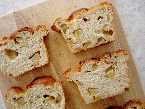 overhead view of slices of apple bread on a wooden board