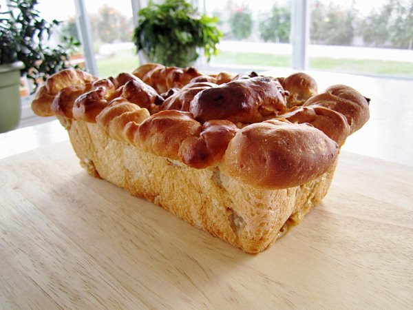 a loaf of apple cinnamon bread on a wooden board