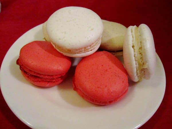 A plate of white and red macaron cookies