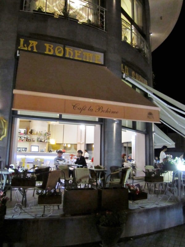 exterior of a restaurant at night with a sign that says La Boheme