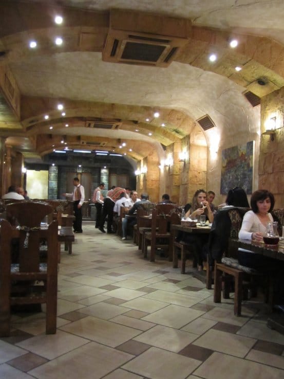 interior of a restaurant with dark wooden tables and chairs