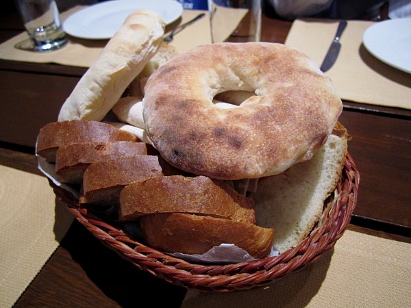 a bread basket with a variety of breads in it