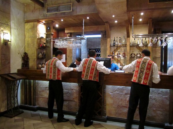 A group of people in uniforms standing in front of a restaurant bar