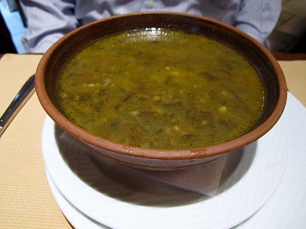 A close up of a bowl of soup on a table