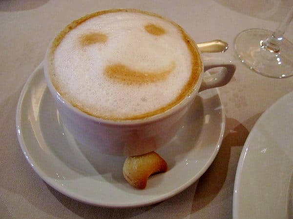 a cappuccino with a smiley face on top