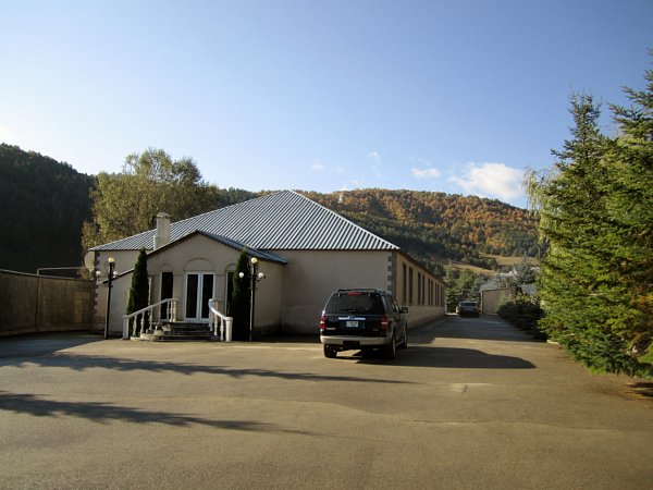 A house with a large paved area in front and along the side