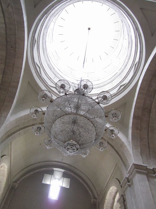 view looking up at a chandelier in a church