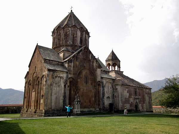 An old large church with a green field in front of it