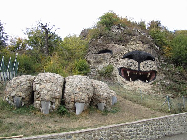 a large rock on a hillside made to look like a lion