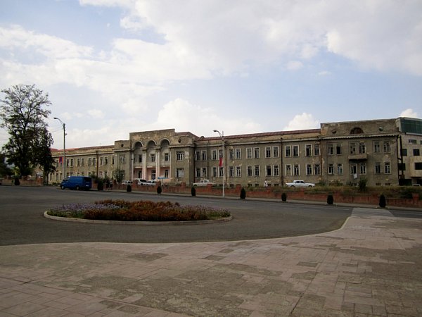 A large stone building on a street