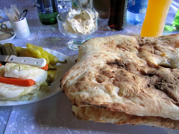 A closeup of bread and pickled vegetables on a table