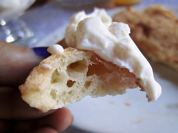 A closeup of a piece of bread topped with strained yogurt