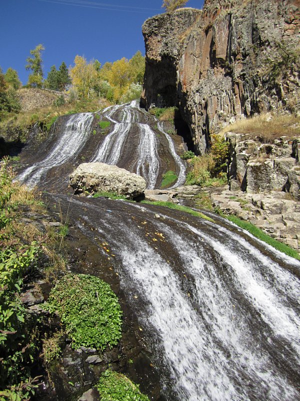 A large waterfall over a rocky surface