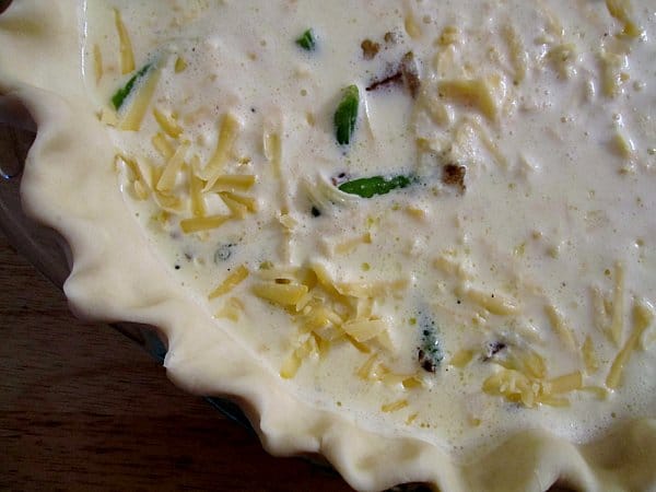 overhead closeup of an unbaked quiche