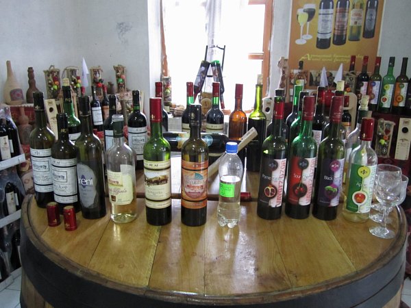 a row of wine bottles on a wooden surface