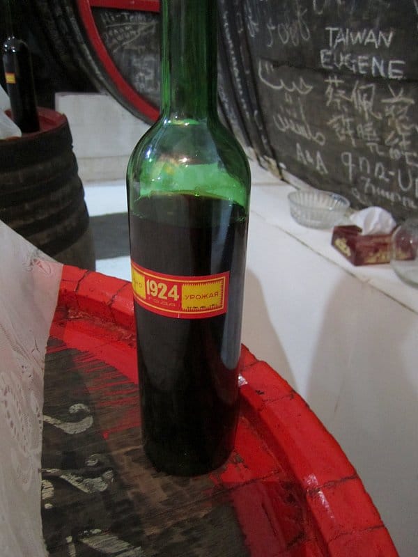 A bottle of alcohol with a red and yellow label