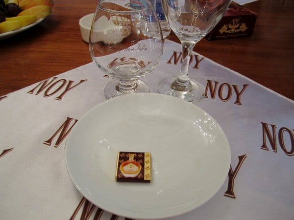 A closeup of a place setting on a table with a white plate and glasses