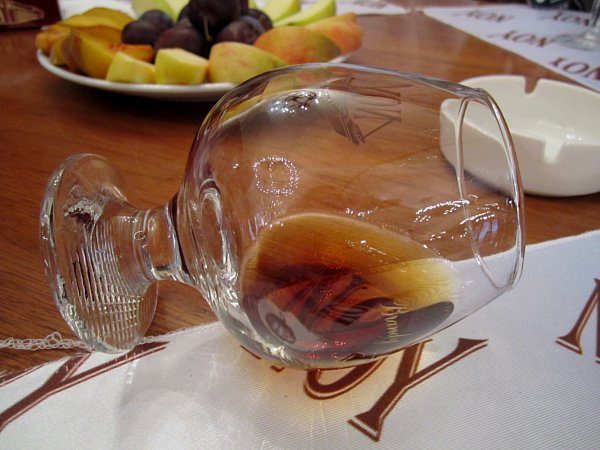 a closeup of a glass of brandy held sideways