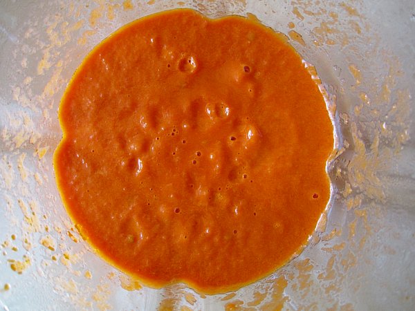 overhead view of a blender jar filled with pureed tomato sauce