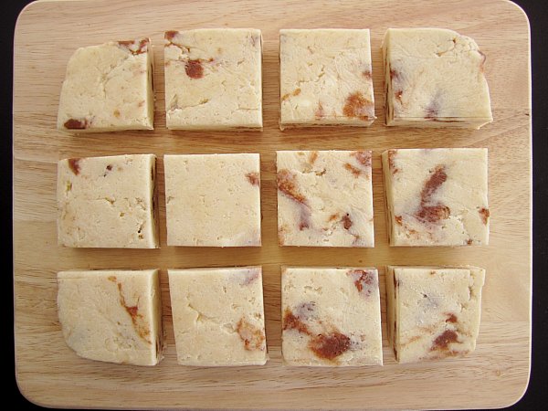 overhead view of unbaked square cinnamon honey scones on a wooden board