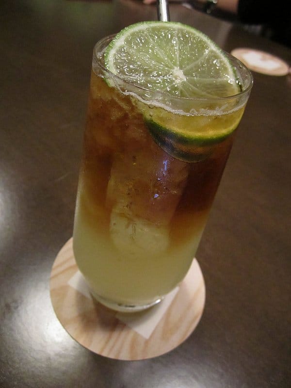 a closeup of a cocktail with slices of lime on top