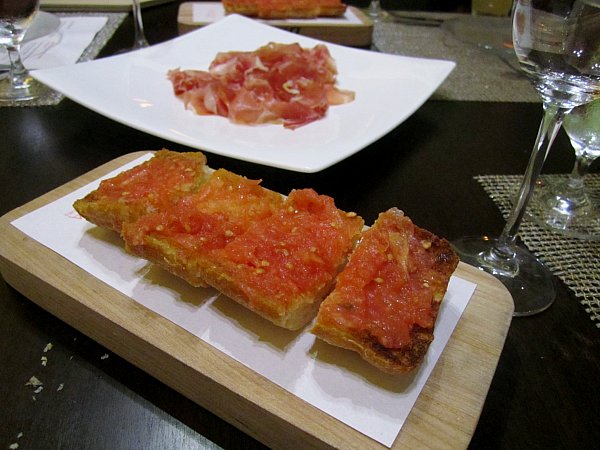 crispy pieces of bread rubbed with tomato on a wooden board