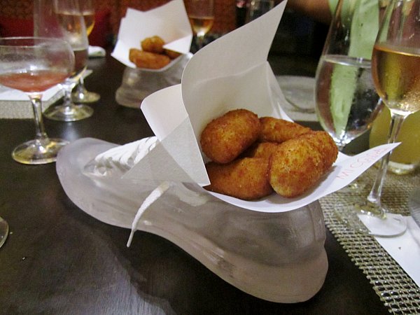 a sneaker shaped serving dish filled with fried croquettes