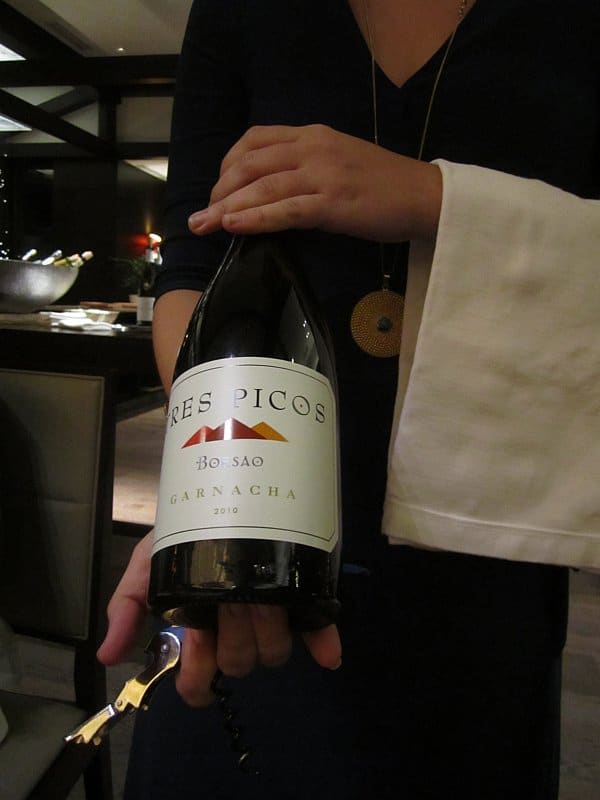 A person holding a bottle of wine