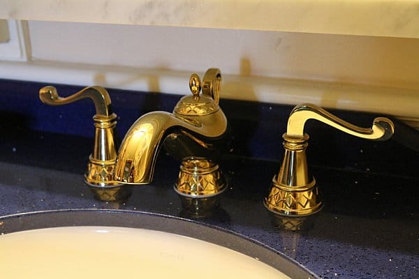 a closeup of gold bathroom fixtures that look like Genie\'s lamp