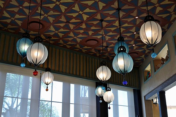 white and blue lights hanging from a colorful ceiling