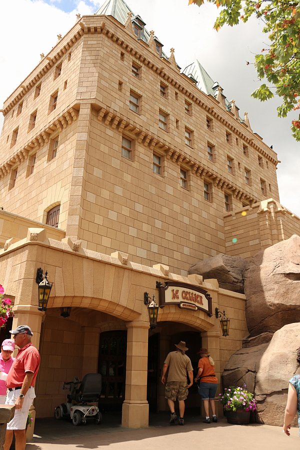 a stone building with some people in front