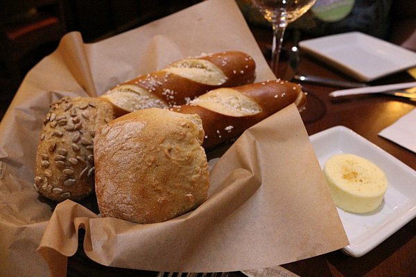 A basket of breads including pretzel sticks