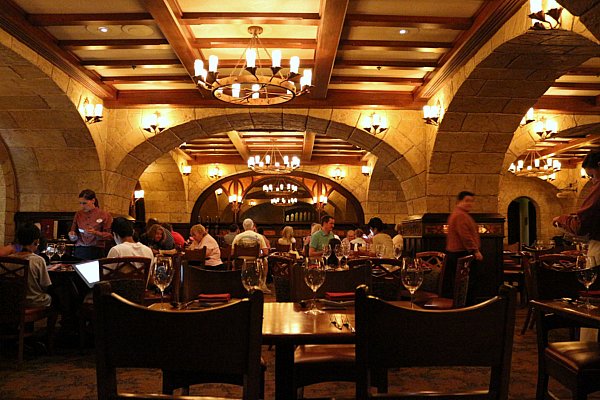 A dark restaurant dining room with warm lighting