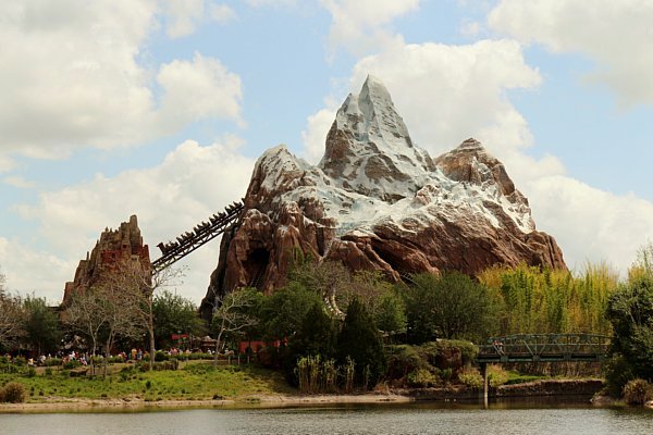 An artificial mountain with a roller coaster climbing up to it