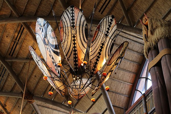 A closeup of an African themed decoration hanging from a ceiling