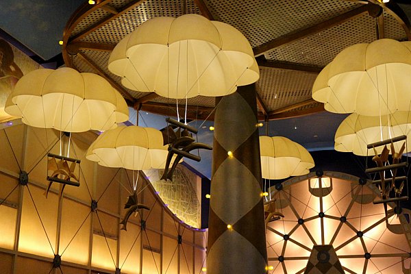 a closeup of yellow parachutes hanging from the ceiling in a restaurant