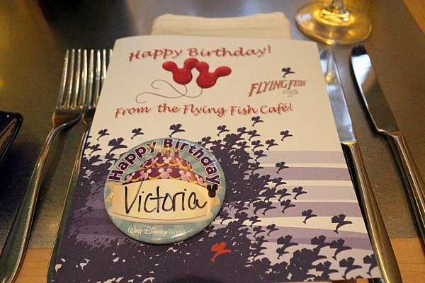 a paper that says Happy Birthday from the Flying Fish Cafe and a birthday button