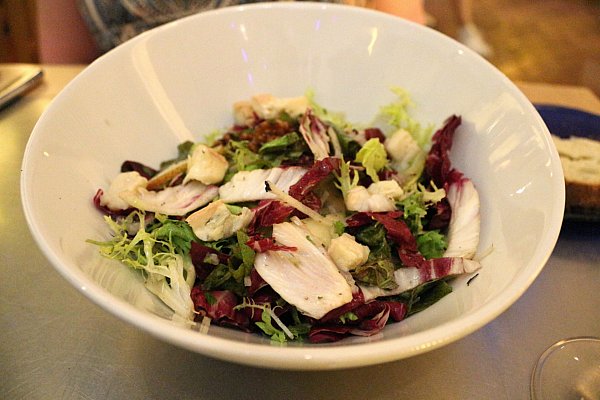 a colorful salad in a white bowl